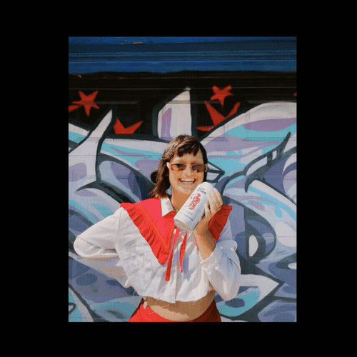 Animated portrait of a woman holding an ART WRKS can in front of a colourful mural.
