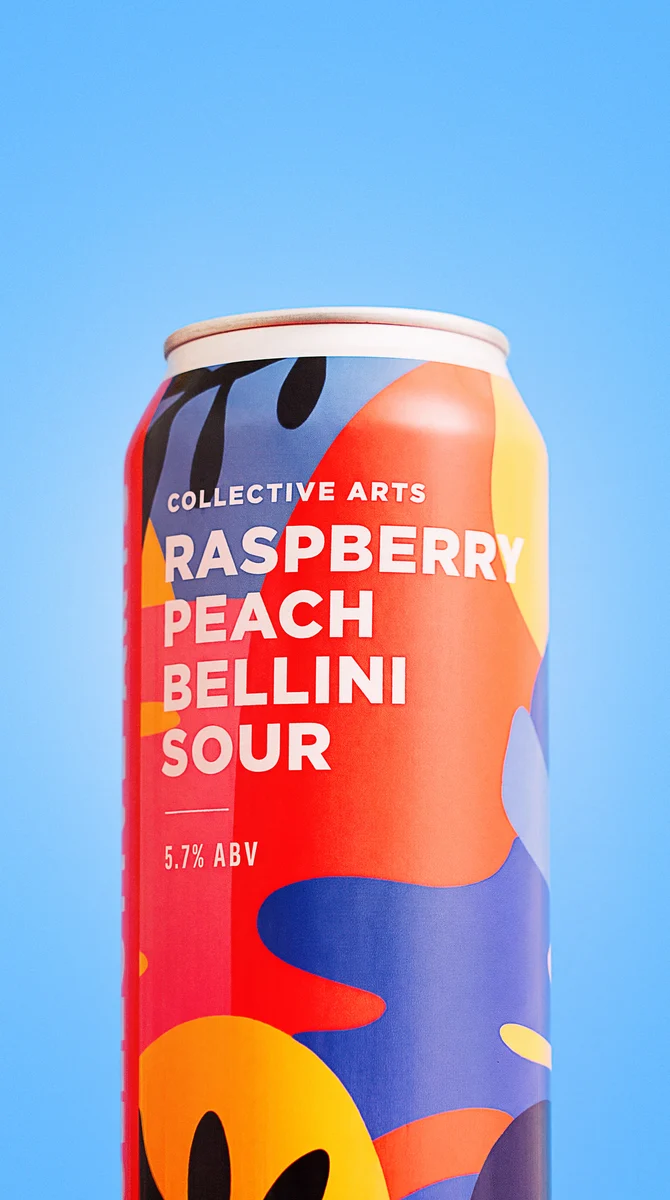 Close-up of a Collective Arts Raspberry Peach Bellini Sour can against a bright blue background.